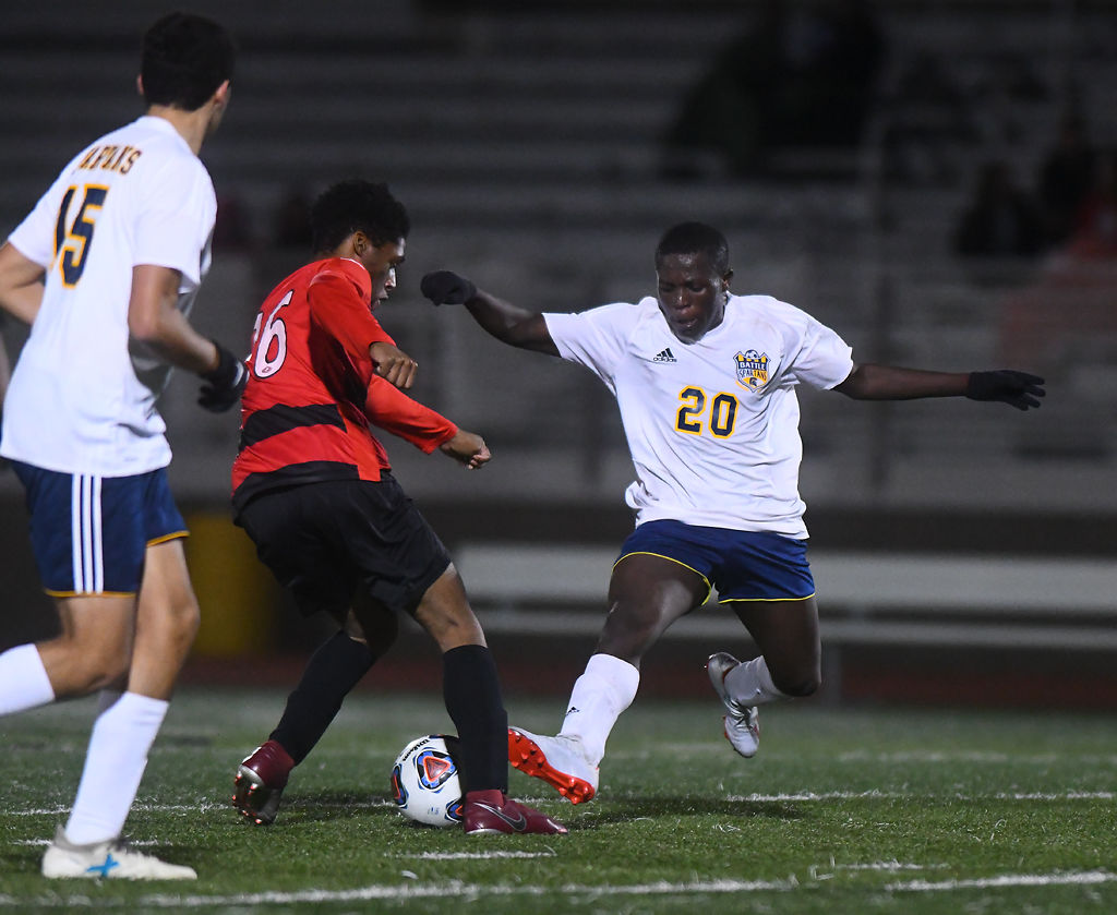 Ismail Senga attempts to tackle the ball from Jefferson City forward Oddie Ihenacho
